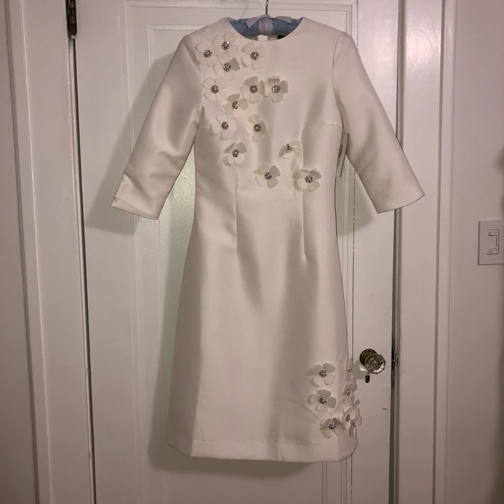 White dress with floral appliqué